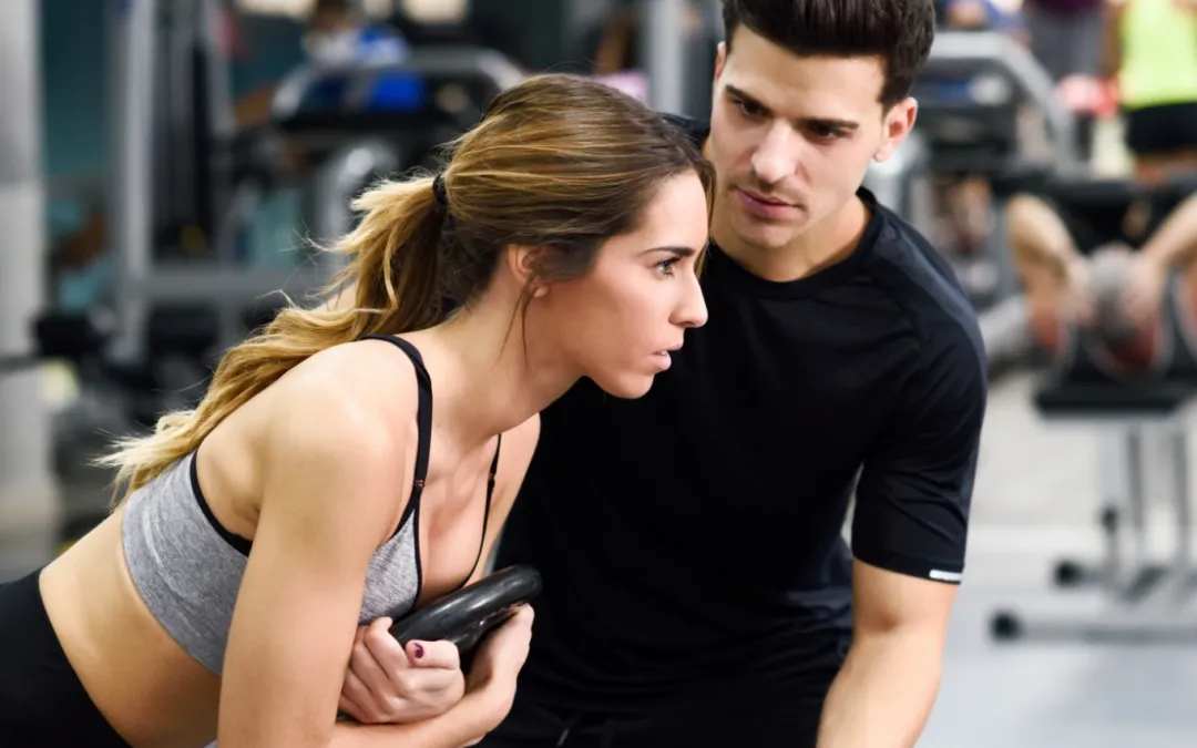 A coach helping a member train with control